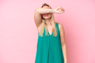 Young caucasian woman isolated on pink background covering eyes by hands