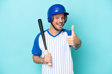 Baseball player with helmet and bat isolated on blue background with thumbs up because something good has happened