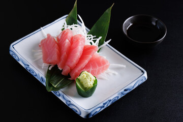 Tuna sashimi isolated in black background - 650141445