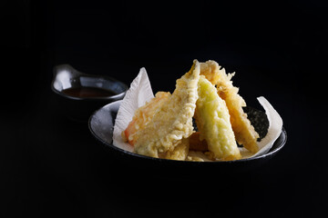 Mix tempura with shrimp fish and vegetable Japanese food isolated in black background - 650141601