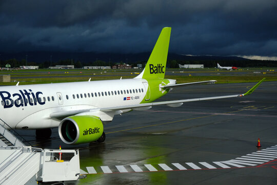 Air Baltic Airbus A220 at Oslo Gardermoen airport with storm approaching