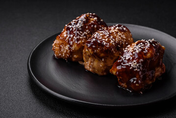 Delicious juicy fried chicken with sweet and sour teriyaki sauce and sesame seeds