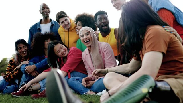 Multicultural group of friends having fun together outdoor - Diversity and multiethnic community concept