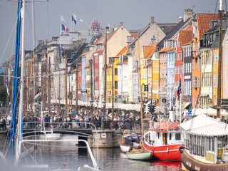 many tourists in front of the colorful Houses in Nyhavn, Copenhagen on a sunny day