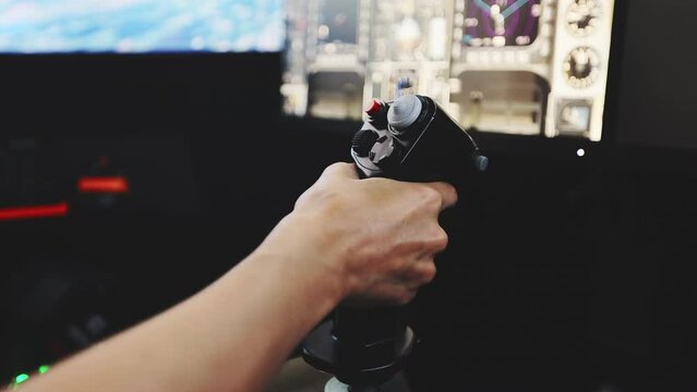Close up of female hand holding gaming joystick in flight simulator and adjusting flight height. Virtual pilot's cabin with control panel, screen and switches. Concept of flight control system.