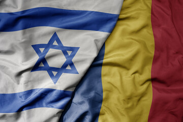 big waving national colorful flag of israel and national flag of romania .