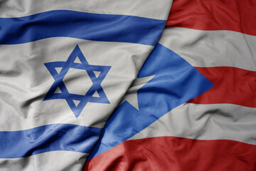 big waving national colorful flag of israel and national flag of puerto rico .