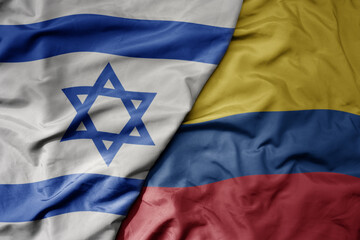 big waving national colorful flag of israel and national flag of colombia .