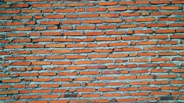 Unfinished red brick wall or tembok bata merah. Batu bata wall. Vintage wall background and texture.