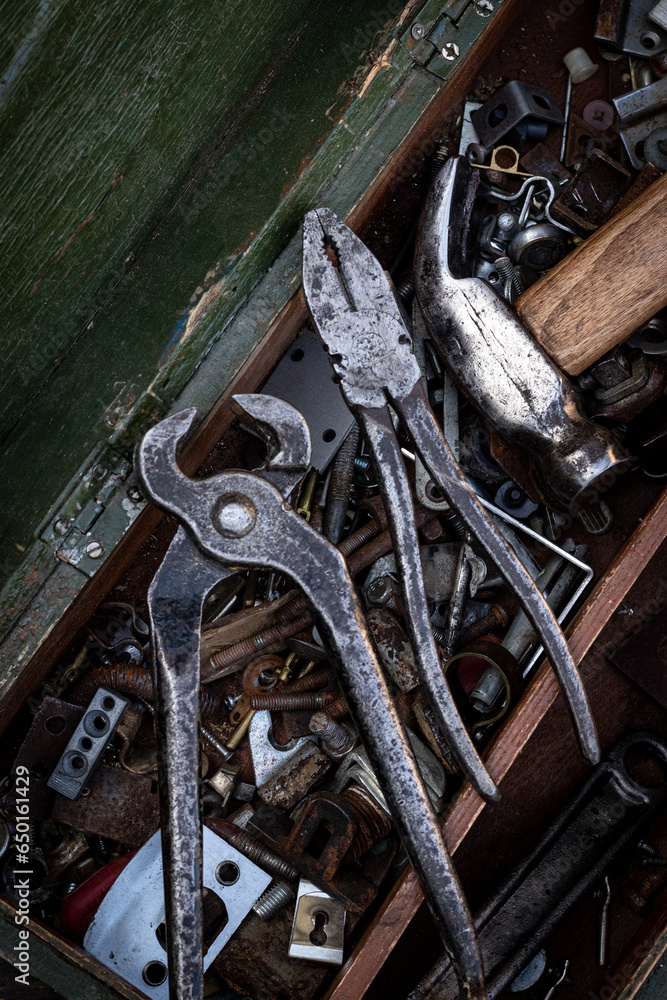 Wall mural old work tools lie on a wooden tool box