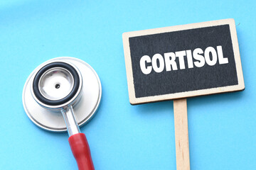 CORTISOL word on a chalkboard next to a stethoscope.