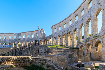 The ruins of the Roman arena in the Croatian city of Pula under a blue sky on a sunny day