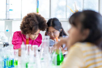 Group of boys and girls who love science Having fun doing experiments in the school lab.