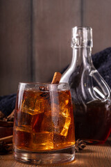 Maple syrup autumn cocktails. Boozy strong alcohol, non-alcoholic mocktail drinks with apple cider, liqueur and spices, on dark wooden background copy space