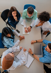 A medical team of doctors discussing and planning at a meeting in the conference room top view.