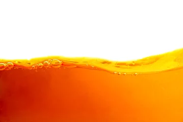 Foto op Plexiglas Orange liquid splash isolated on white background. Close up of orange liquid. © nirats