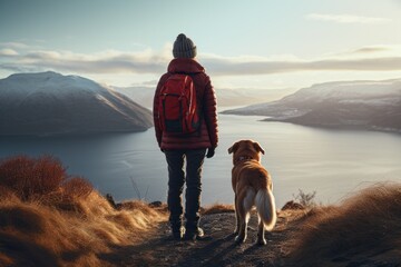 A person standing on a hill with their loyal dog by their side. This image captures the beauty of...