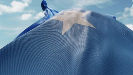 Wavy flag of Somalia blowing in the wind in slow motion. Waving official Somalia flag team symbol abstract vertical background. Blue sky with clouds. World countries flying flags concept