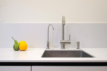Faucet and steel sink in the kitchen