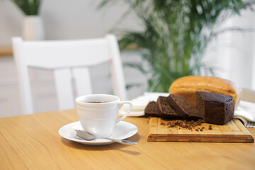 Coffee cup and bread on table