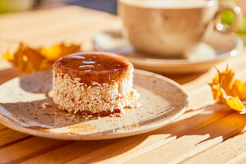 Vegetarian carrot cake with agave syrup. No baking and no sugar dessert with cup of coffee. Healthy breakfast outside