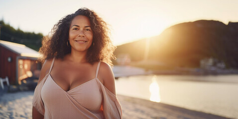 Lifestyle portrait of voluptuous middle aged woman standing by seaside cabin on fjord beach - Powered by Adobe