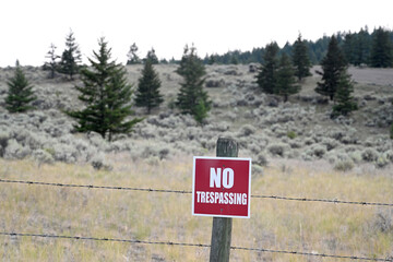 Sign NO TRESPASSING in mountains.
