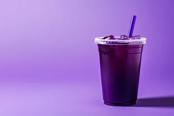 Foto op Plexiglas Purple drink in a plastic cup isolated on a purple background. Take away drinks concept with copy space © agungai