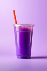 Purple drink in a plastic cup isolated on a purple background. Take away drinks concept
