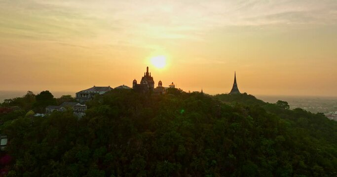 aerial view The rays of the sun shine atop the hilltop castle at Phetchaburi Thailand..Built by King Rama IV in 1859 The first palace in Thailand to be build on a mountain. .golden sky background.