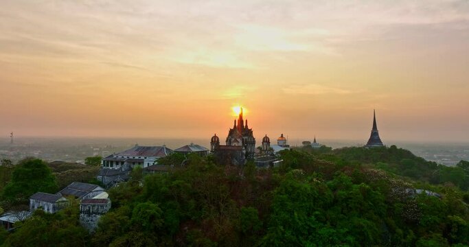 aerial view The rays of the sun shine atop the hilltop castle at Phetchaburi Thailand..Built by King Rama IV in 1859 The first palace in Thailand to be build on a mountain. .golden sky background.