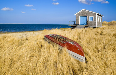 New England Boathouse with Row Boat and Golden Marsh Grass at Chatham, Cape Cod - obrazy, fototapety, plakaty