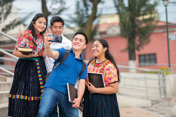 A group of students taking a selfie with a cell phone.