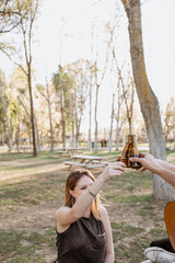 Young musicians drinking beer in park