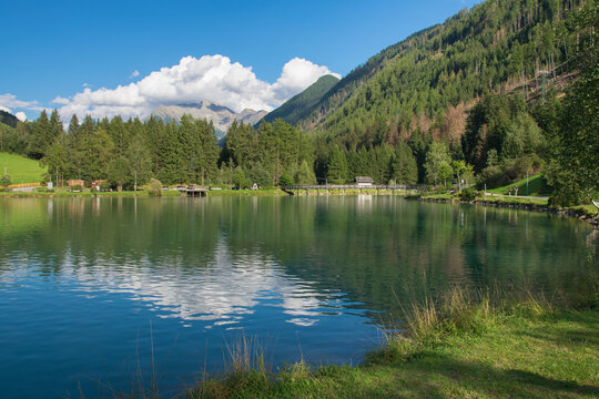 Panoramic view of alpine lake in the little village of Selva dei Molini, Zillertal alps, Italy