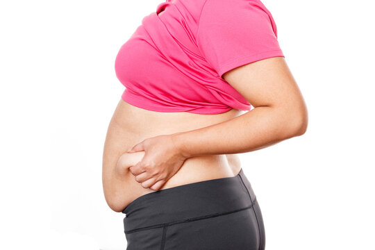 Woman touching his fat belly on white background. Woman hand holding excessive belly fat