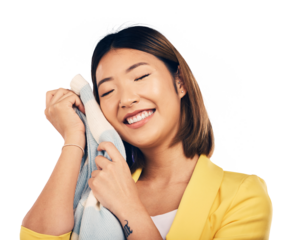Woman, holding soft jersey and comfort, happy and isolated on transparent png background with quality fashion texture. Asian model, material and excited with fabric product, fresh laundry and smile.