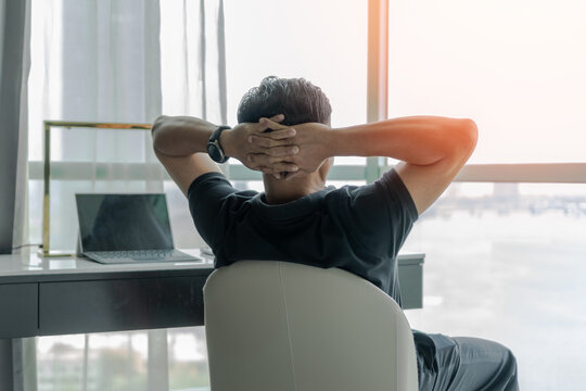 Work-life balance and living life style concept of businessman relaxing, take it easy in hotel or office room resting with thoughtful mind thinking of lifestyle quality looking forward to city