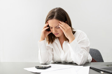 Stressed Businesswoman At Laptop Touching Head Having Headache At Workplace
