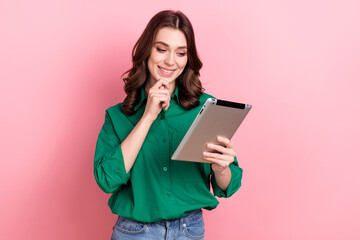 Photo of thoughtful pretty lady wear green shirt typing email modern gadget hand arm chin isolated pink color background