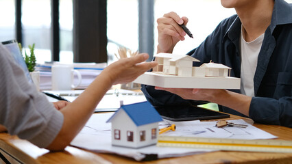 Engineer working on table and explain to customers