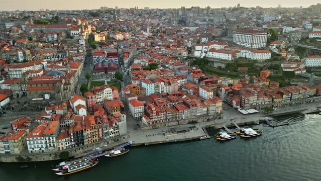 Morning aerial view of Porto downtown, Portugal. Old houses with orange roofs, Duero river and boats in the central part of Porto city. UHD, 4K, Aerial