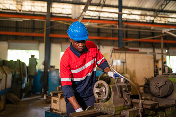 Male technician worker working and repair pressing metal machine at factory, Machine maintenance technician operation concept.	