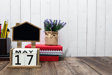 th May calendar date text on white wooden block with stationeries on wooden desk