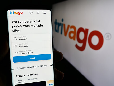 Stuttgart, Germany - 09-14-2023: Person holding cellphone with web page of German hotel metasearch company Trivago N.V. on screen with logo. Focus on center of phone display.