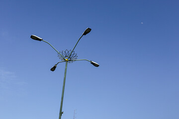 Automatic street lamp pole with solar panel system over the clear blue sky background