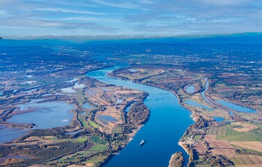 Aerial view of Sauvie island farm and wildlife area and the Columbia River leading west toward...
