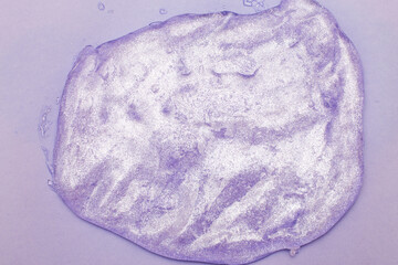 Glitter slime on purple background. squishy slimy texture