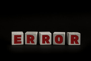 Obraz premium Word ERROR written with wooden cubes. Studio shot of some arranged wooden blocks with a textual message.