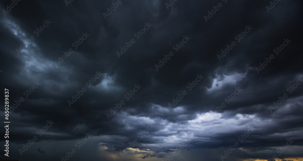 Poster Bad or moody weather sky and environment.The dark sky with heavy clouds converging and a violent storm before the rain.carbon dioxide emissions, greenhouse effect, global warming, climate change